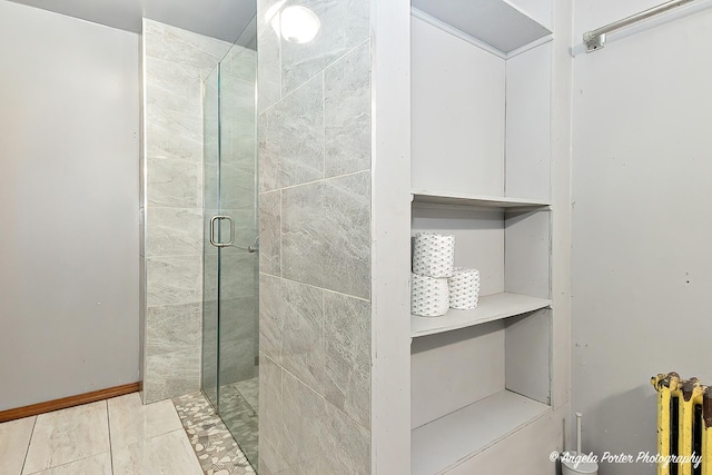 bathroom featuring tile patterned floors and a shower with shower door