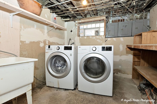 laundry area with separate washer and dryer and sink