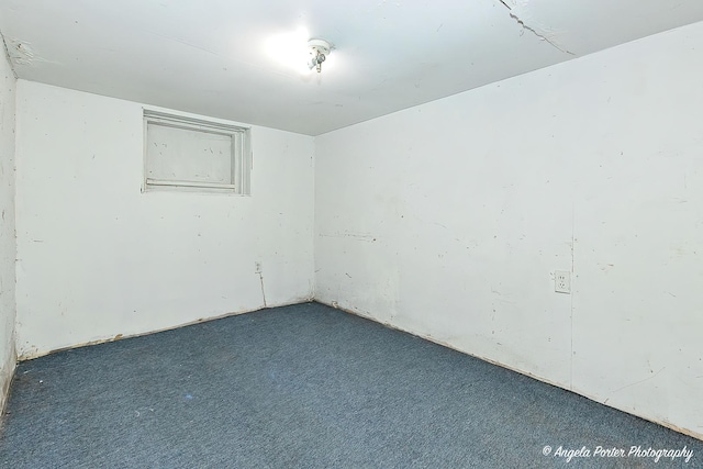 empty room with dark colored carpet