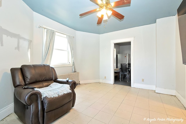 sitting room featuring radiator heating unit and ceiling fan