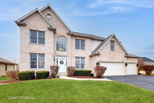 view of property featuring a garage and a front lawn