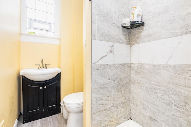 bathroom with hardwood / wood-style floors, vanity, and toilet