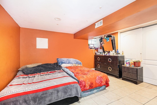 bedroom featuring light tile patterned flooring and a closet