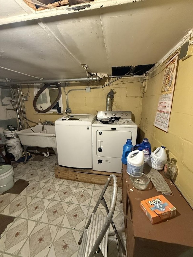 interior space featuring washing machine and clothes dryer and sink