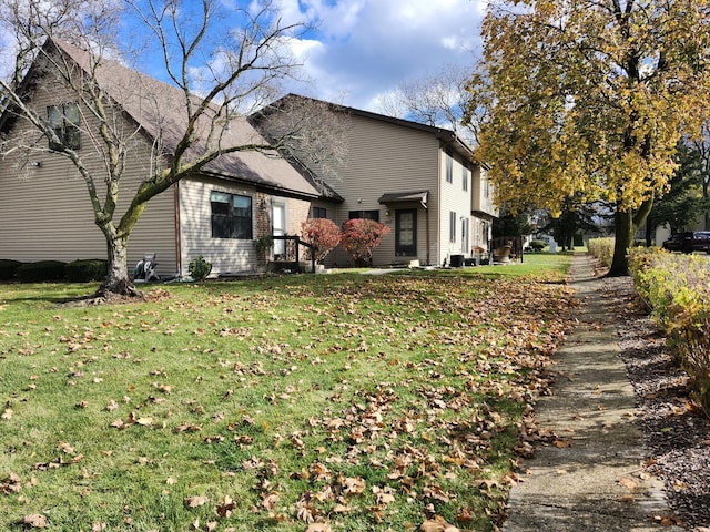 view of side of home featuring a yard