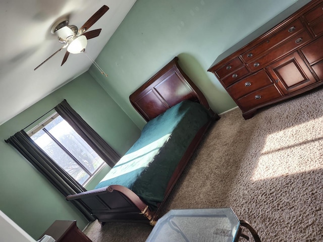 carpeted bedroom featuring ceiling fan and vaulted ceiling