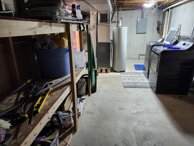 basement with washing machine and dryer, gas water heater, and electric panel