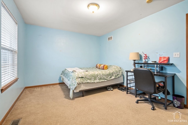 bedroom featuring light colored carpet