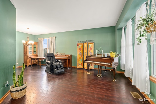 misc room featuring a notable chandelier and dark hardwood / wood-style flooring