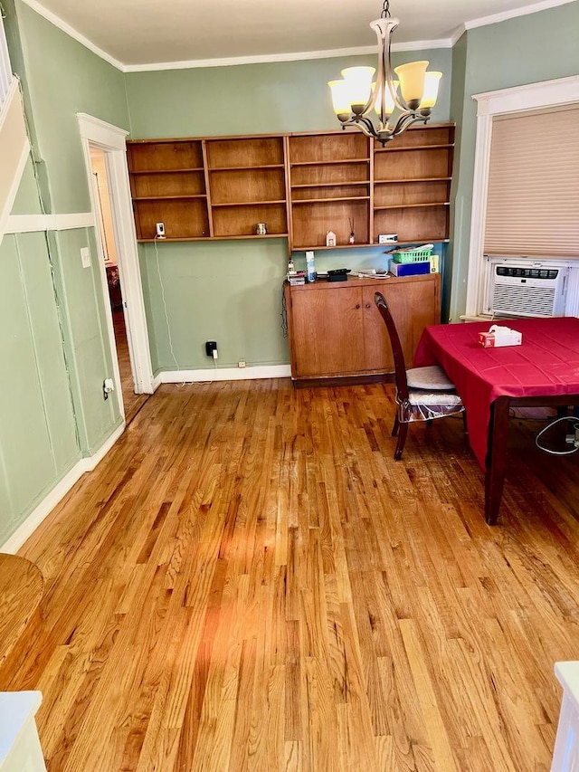 dining space featuring a chandelier, cooling unit, ornamental molding, and light hardwood / wood-style flooring