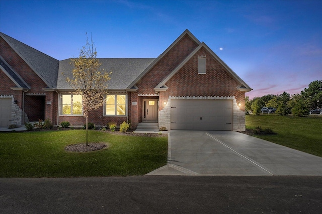 view of front of home featuring a lawn and a garage