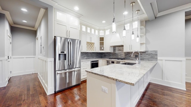 kitchen featuring kitchen peninsula, dark hardwood / wood-style floors, light stone counters, white cabinetry, and stainless steel appliances