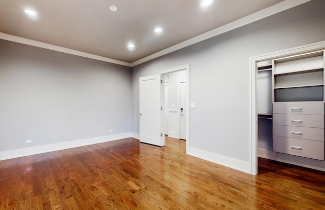 unfurnished bedroom with hardwood / wood-style flooring and crown molding