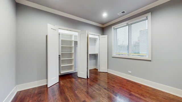 unfurnished bedroom featuring dark hardwood / wood-style floors and ornamental molding