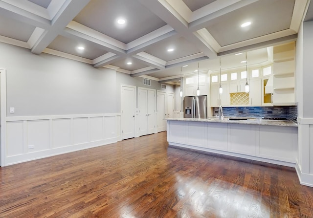 kitchen with appliances with stainless steel finishes, white cabinetry, hanging light fixtures, and dark wood-type flooring