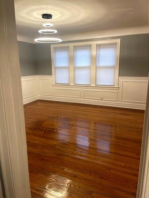 unfurnished room with dark wood-type flooring