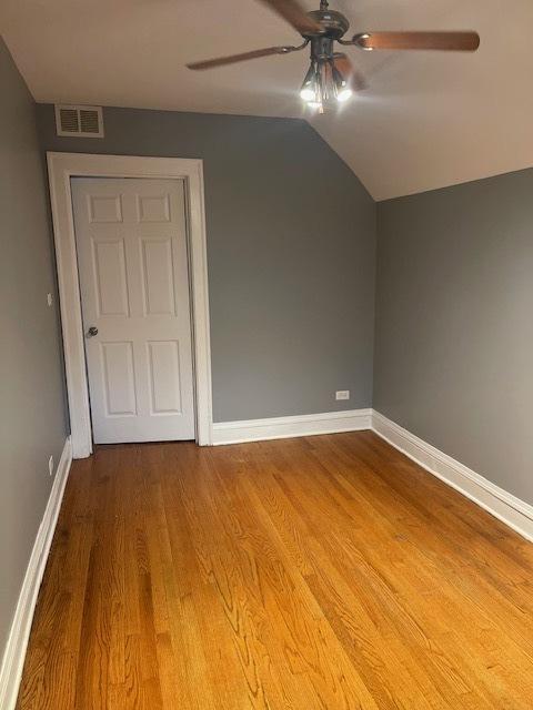 additional living space featuring hardwood / wood-style floors, ceiling fan, and vaulted ceiling