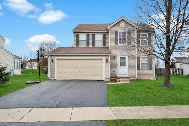 view of front of house featuring a garage and a front lawn