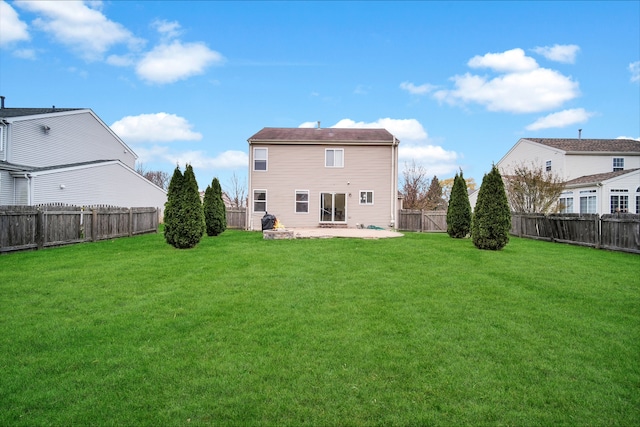 rear view of house featuring a lawn and a patio