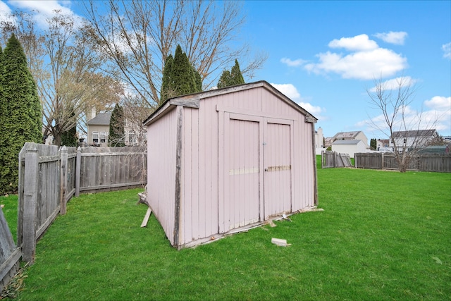 view of outbuilding featuring a lawn