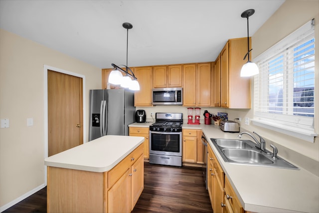 kitchen featuring a center island, sink, stainless steel appliances, dark wood-type flooring, and pendant lighting