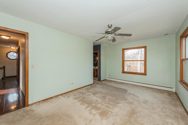 carpeted spare room featuring ceiling fan and a baseboard radiator