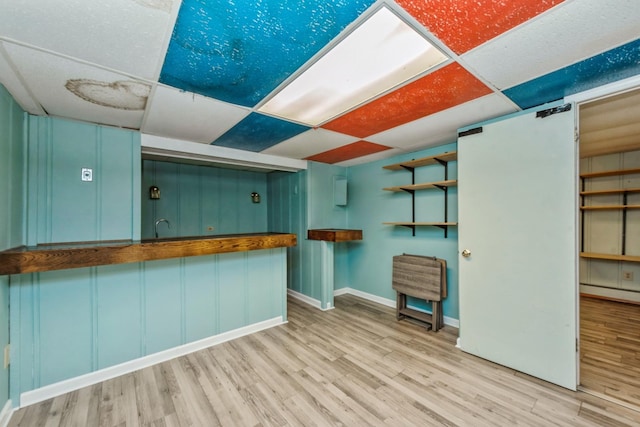 kitchen with a paneled ceiling, light hardwood / wood-style floors, and butcher block counters