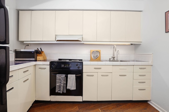 kitchen with sink, range with electric cooktop, dark hardwood / wood-style floors, and custom exhaust hood