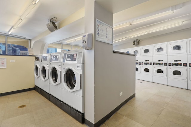 clothes washing area featuring washing machine and dryer and stacked washing maching and dryer