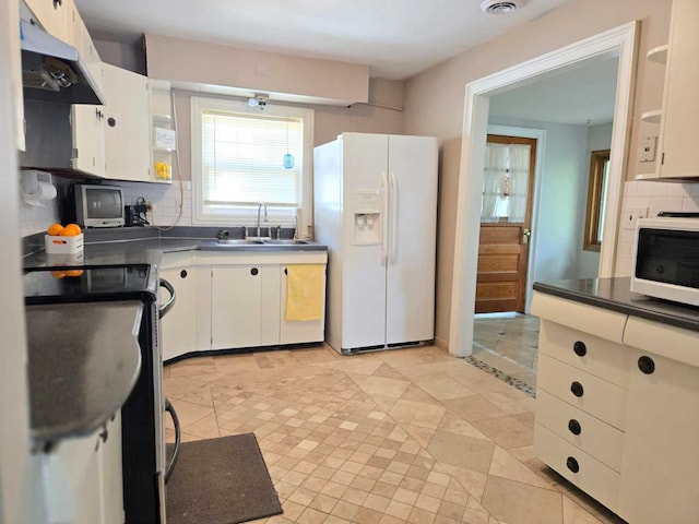 kitchen featuring decorative backsplash, white cabinetry, sink, and white appliances