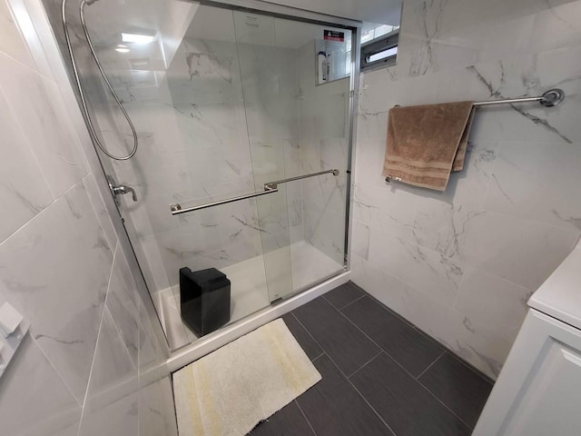 bathroom with a shower with door