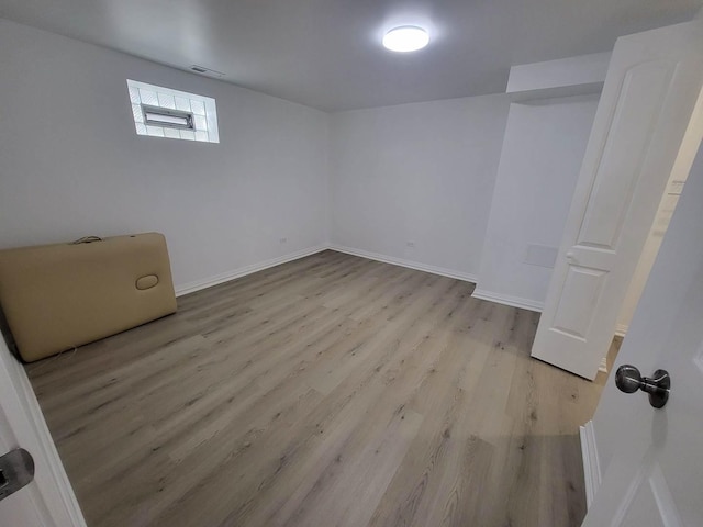 basement featuring light hardwood / wood-style flooring