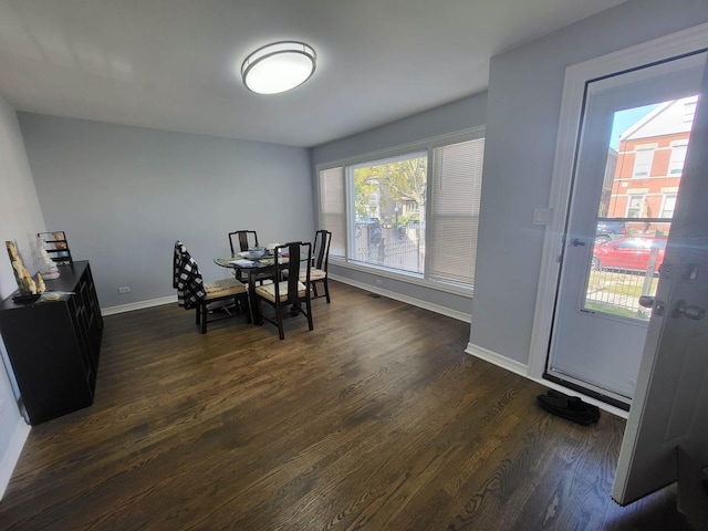 dining space with dark hardwood / wood-style flooring