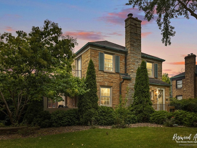 property exterior at dusk with a yard