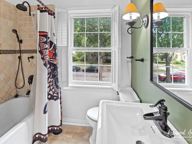 full bathroom with sink, shower / tub combo, and toilet