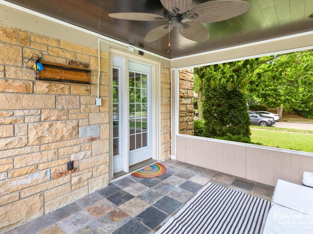 unfurnished sunroom featuring plenty of natural light and ceiling fan