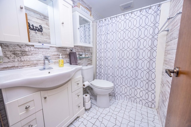 bathroom with vanity, tile patterned flooring, toilet, tile walls, and tasteful backsplash