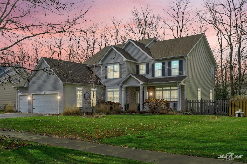 view of front facade with a yard and a garage