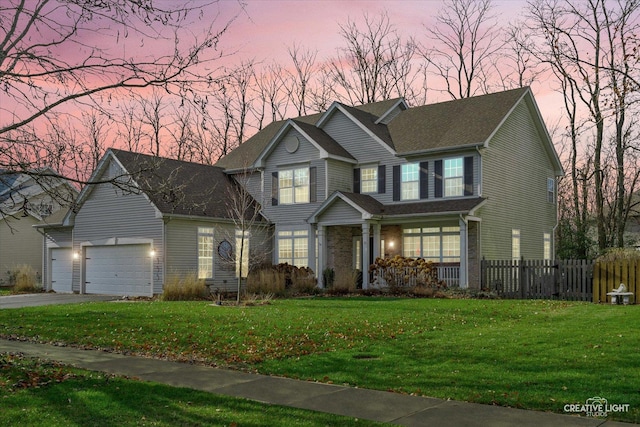 view of front facade with a yard and a garage