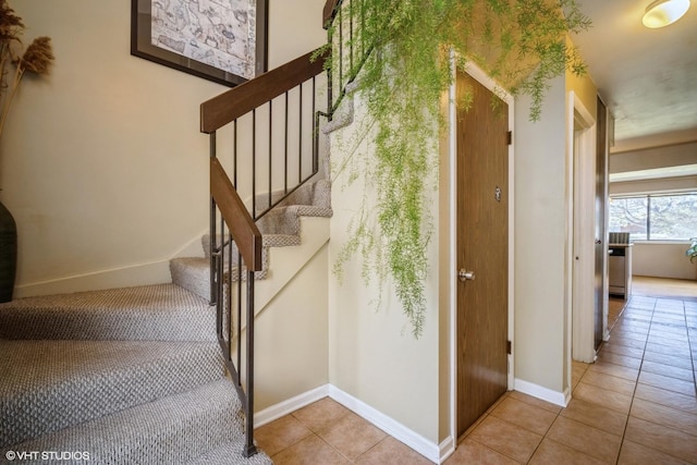 stairway featuring tile patterned flooring