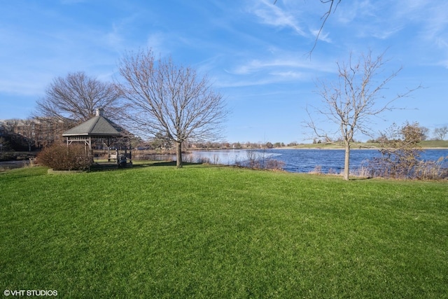 view of yard with a gazebo and a water view