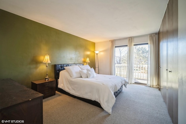 carpeted bedroom with access to exterior