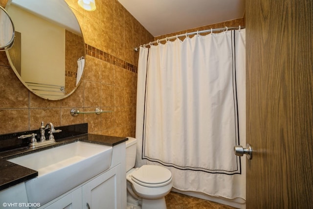 bathroom featuring backsplash, tile patterned floors, toilet, vanity, and tile walls