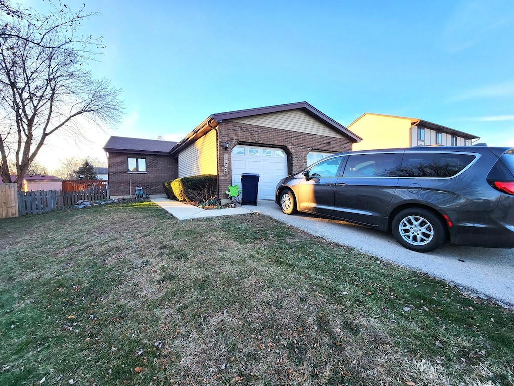 property exterior at dusk featuring a garage and a yard