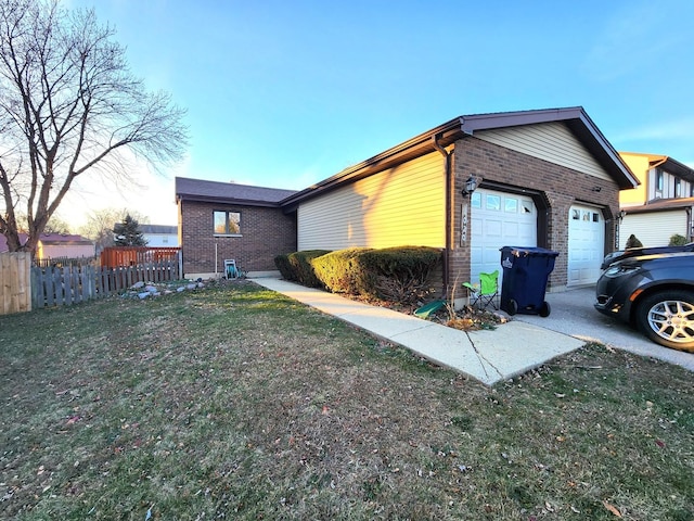 property exterior at dusk with a yard and a garage