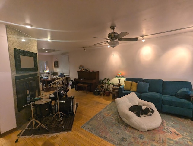 living room featuring ceiling fan and light hardwood / wood-style flooring