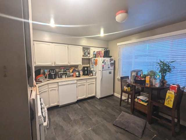 kitchen with white cabinetry and white appliances