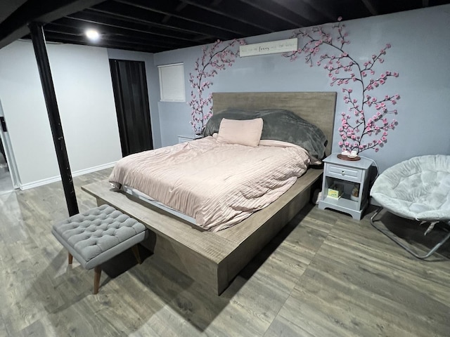 bedroom with hardwood / wood-style flooring