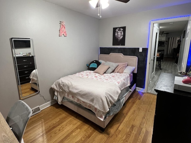 bedroom featuring hardwood / wood-style floors and ceiling fan