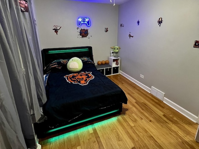 bedroom with hardwood / wood-style floors